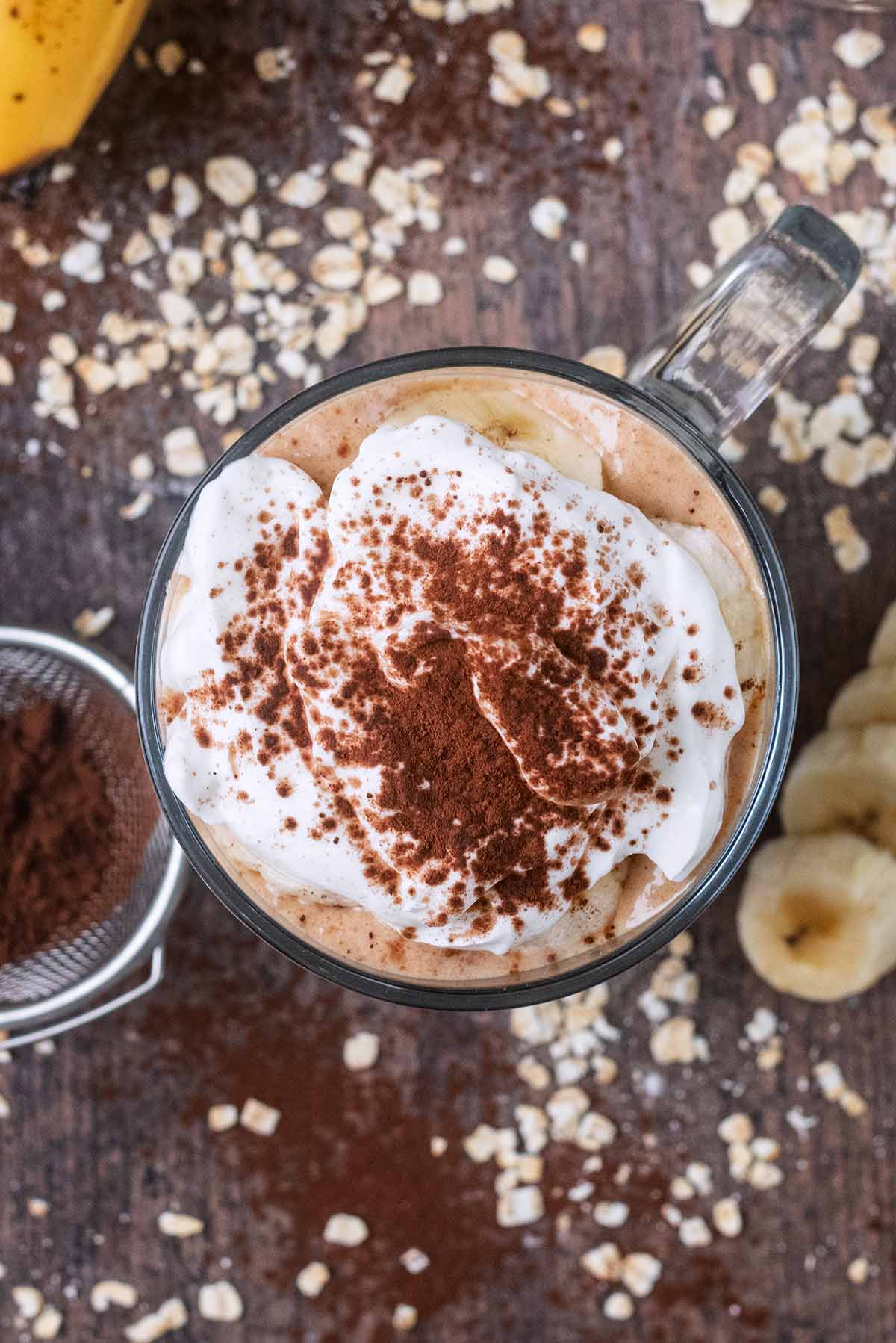 Cocoa powder dusted over some Greet yogurt which is on top of some overnight oats.
