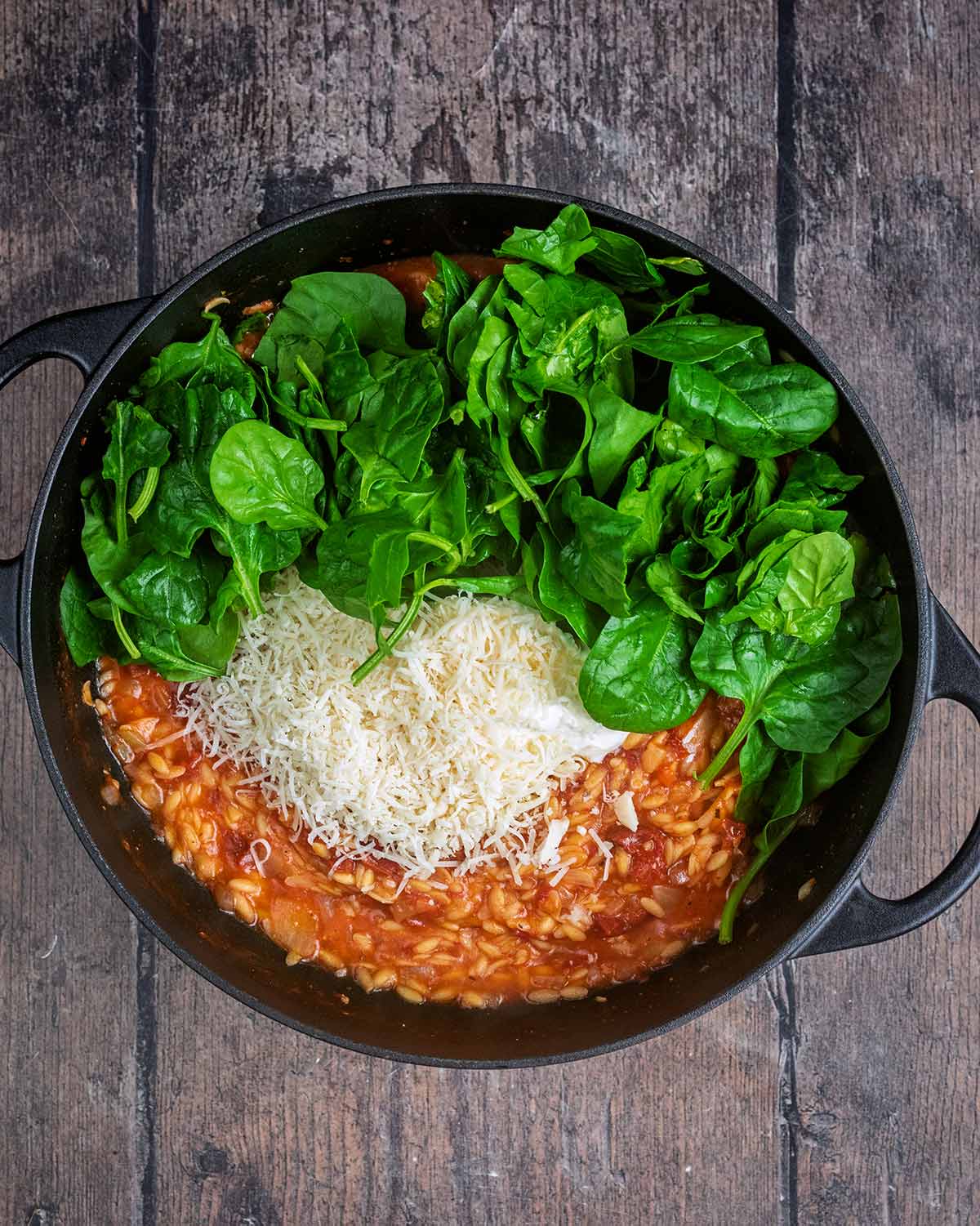 Cream, spinach and cheese added to the pan.