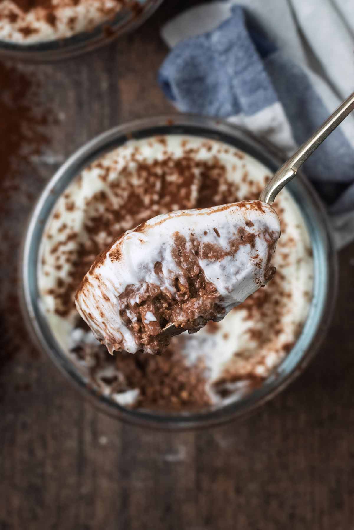 A spoonful of yogurt topped overnight oats.