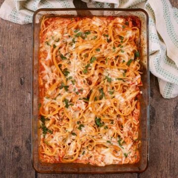 Chicken spaghetti bake in a larg glass baking dish.
