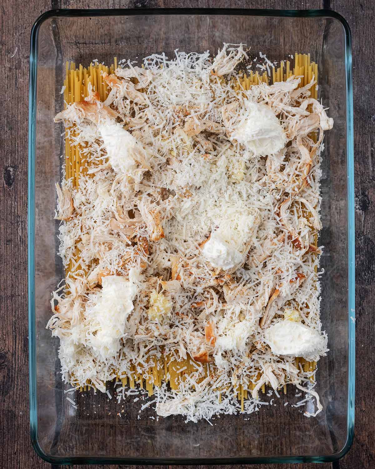 Shredded chicken, cream cheese and grated Parmesan added on top of the spaghetti.