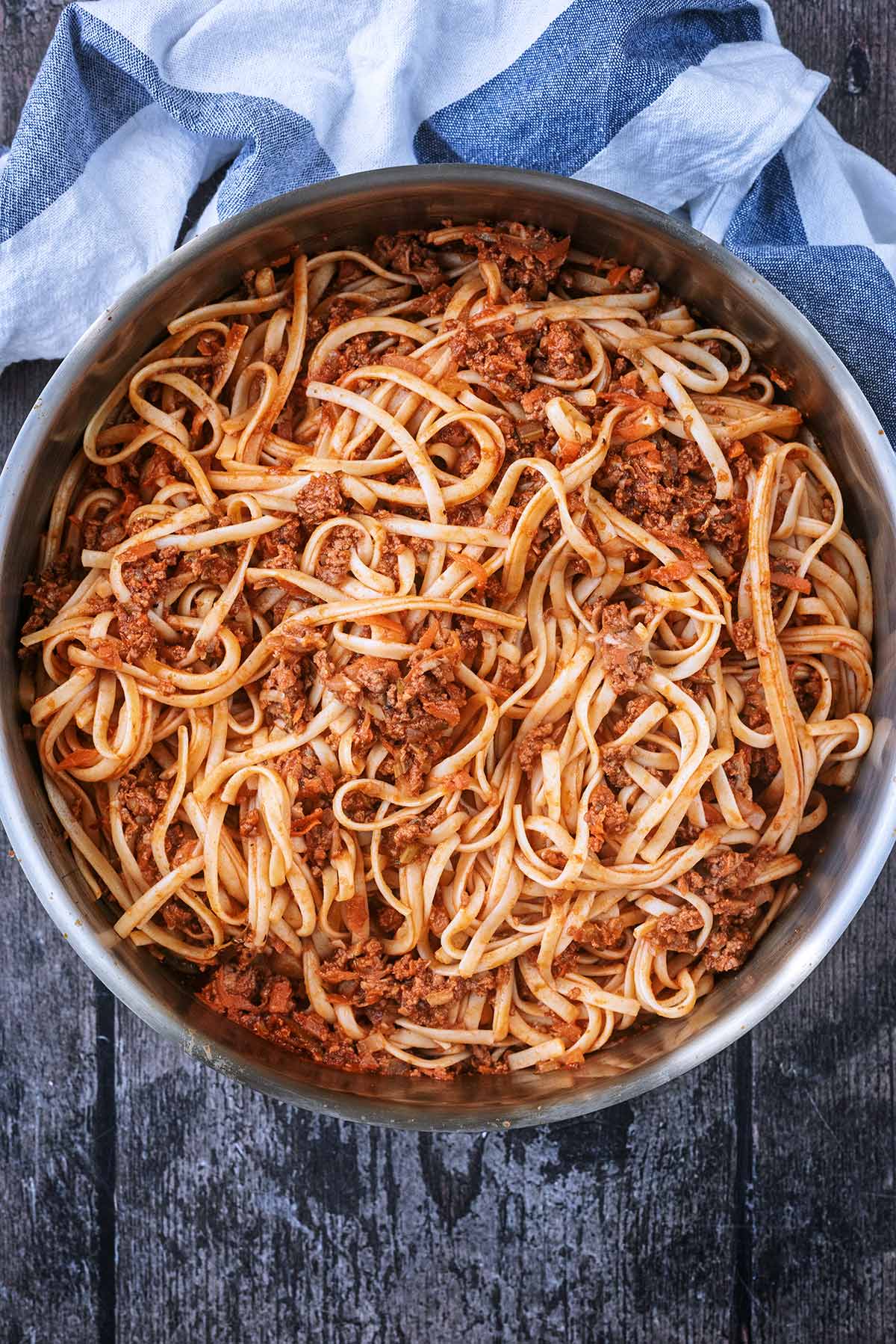 A large stainless steel pan containing bolognese.