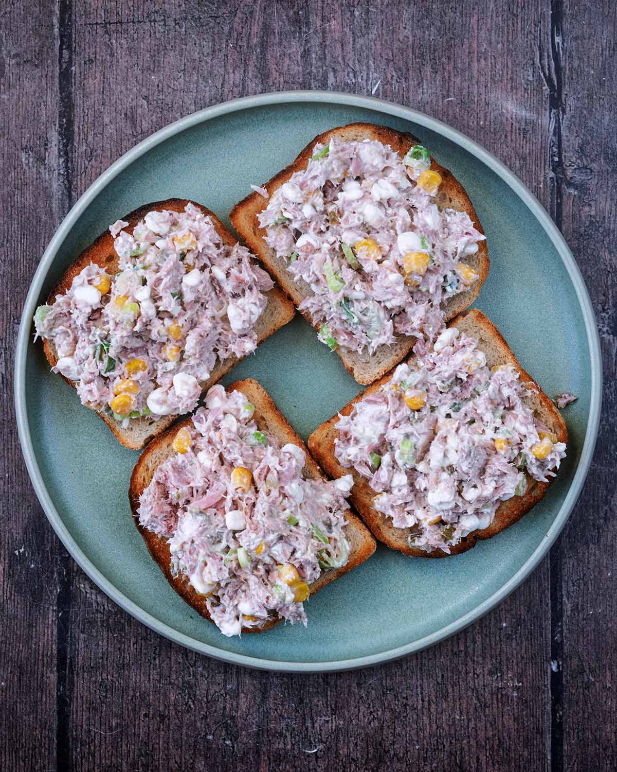 Four slices of toasted bread topped with the tuna mixture.