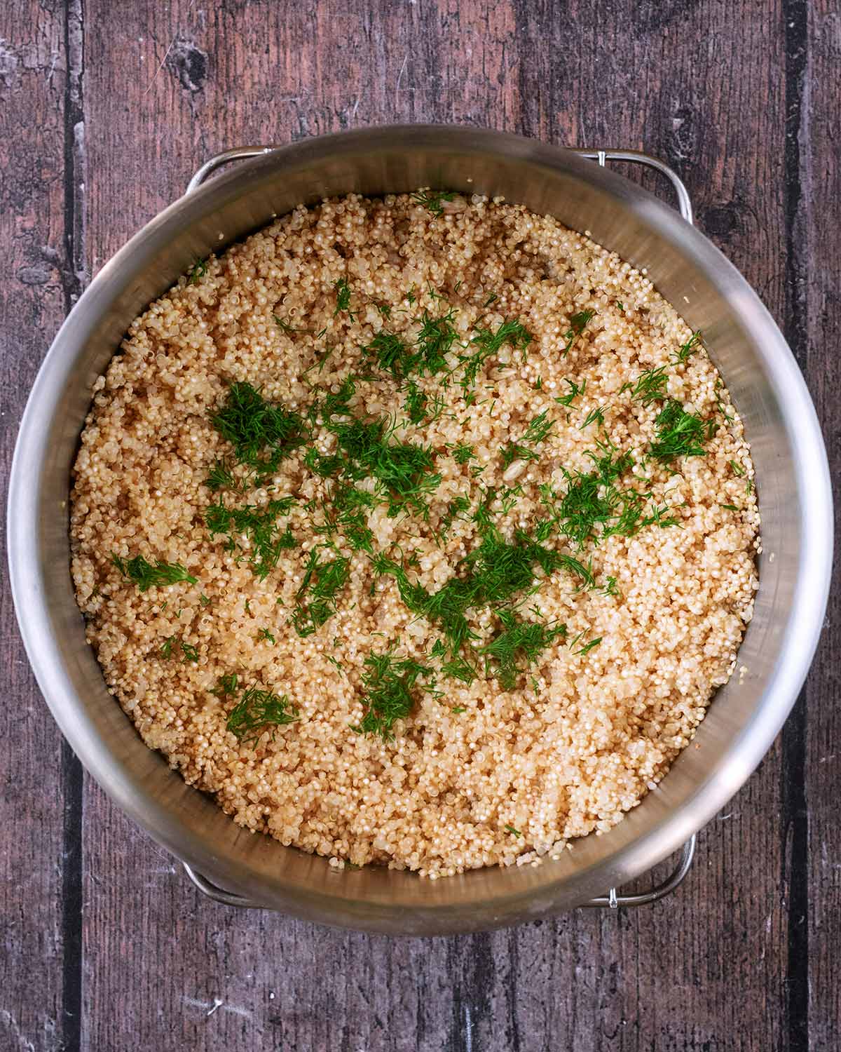 Chopped fresh dill added to the pan of quinoa.