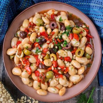 A large bowl of marinated butter beans.