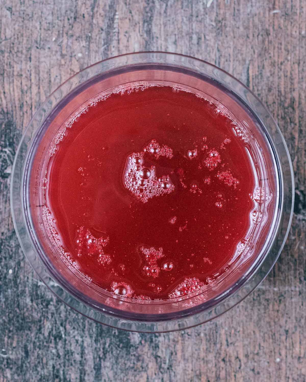 The berry juice and water in the Creami pint tub.