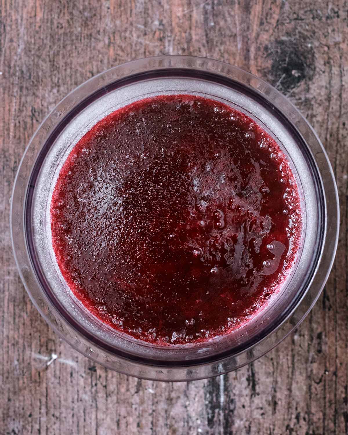 Frozen fruit juice in the Creami pint tub.