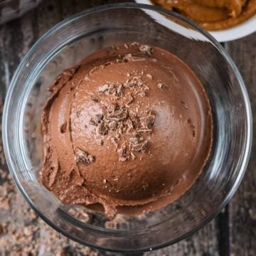 A ball of chocolate peanut butter ice cream in a serving glass.
