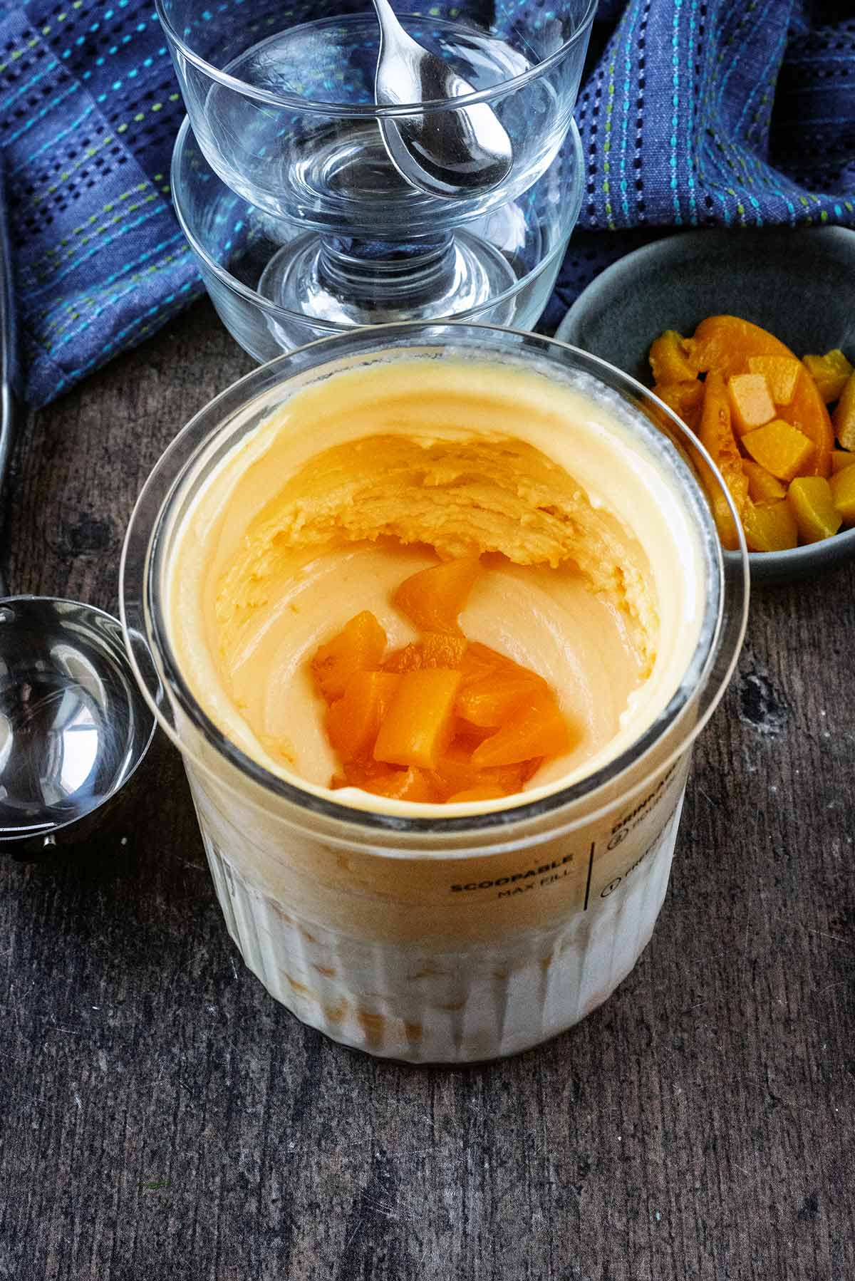 A Ninja Creami tub full of peach ice cream.