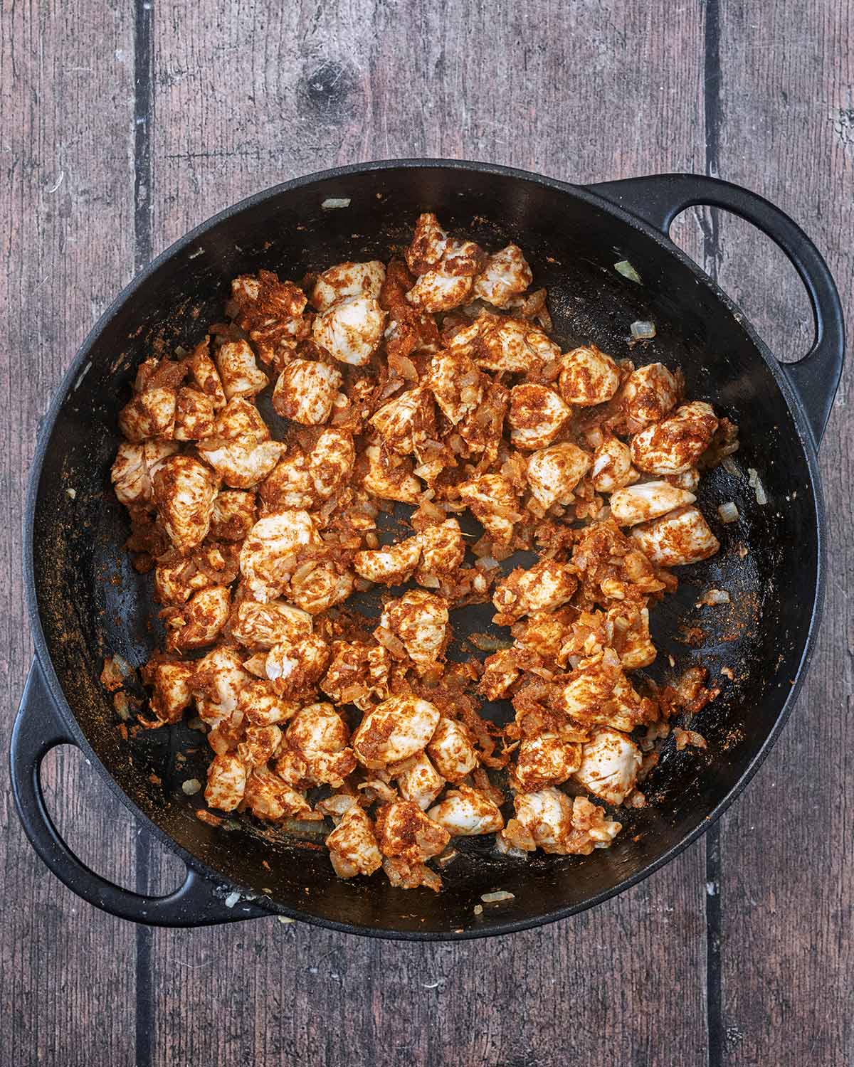 Curry powder added to the chicken and onions.