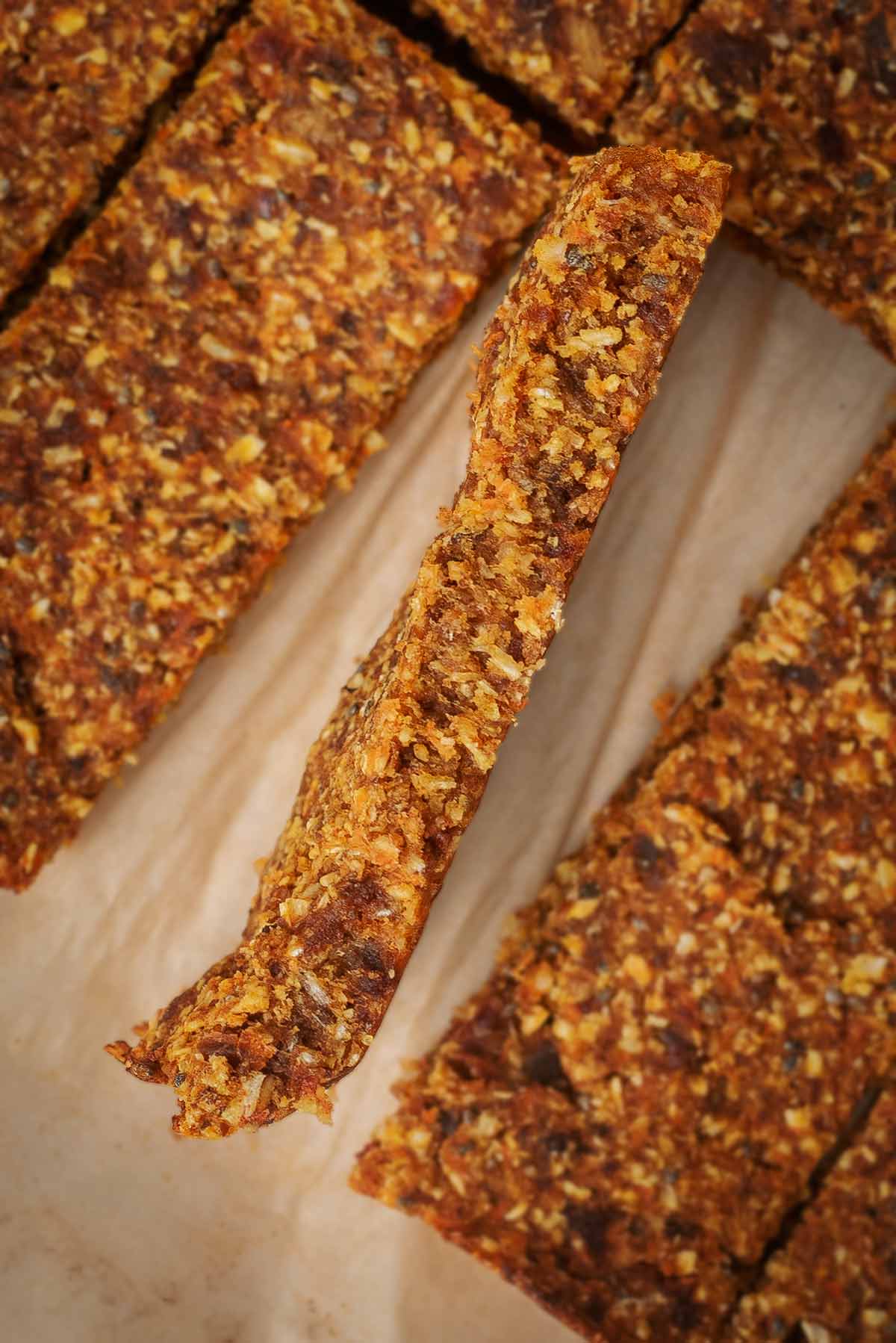 An oat bar sat on its side amongst other bars that are laying flat.