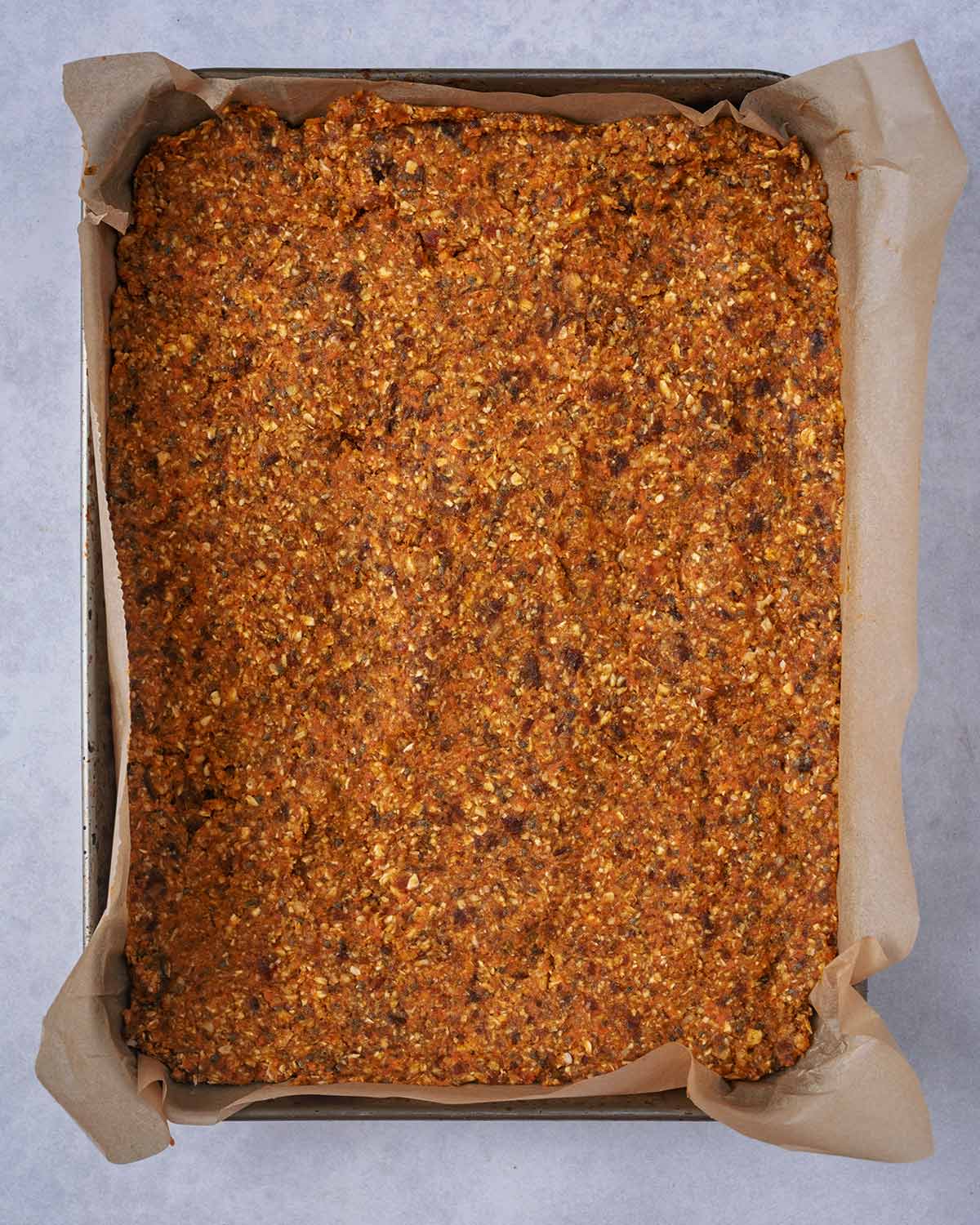 The mixture pressed into a lined baking tray.