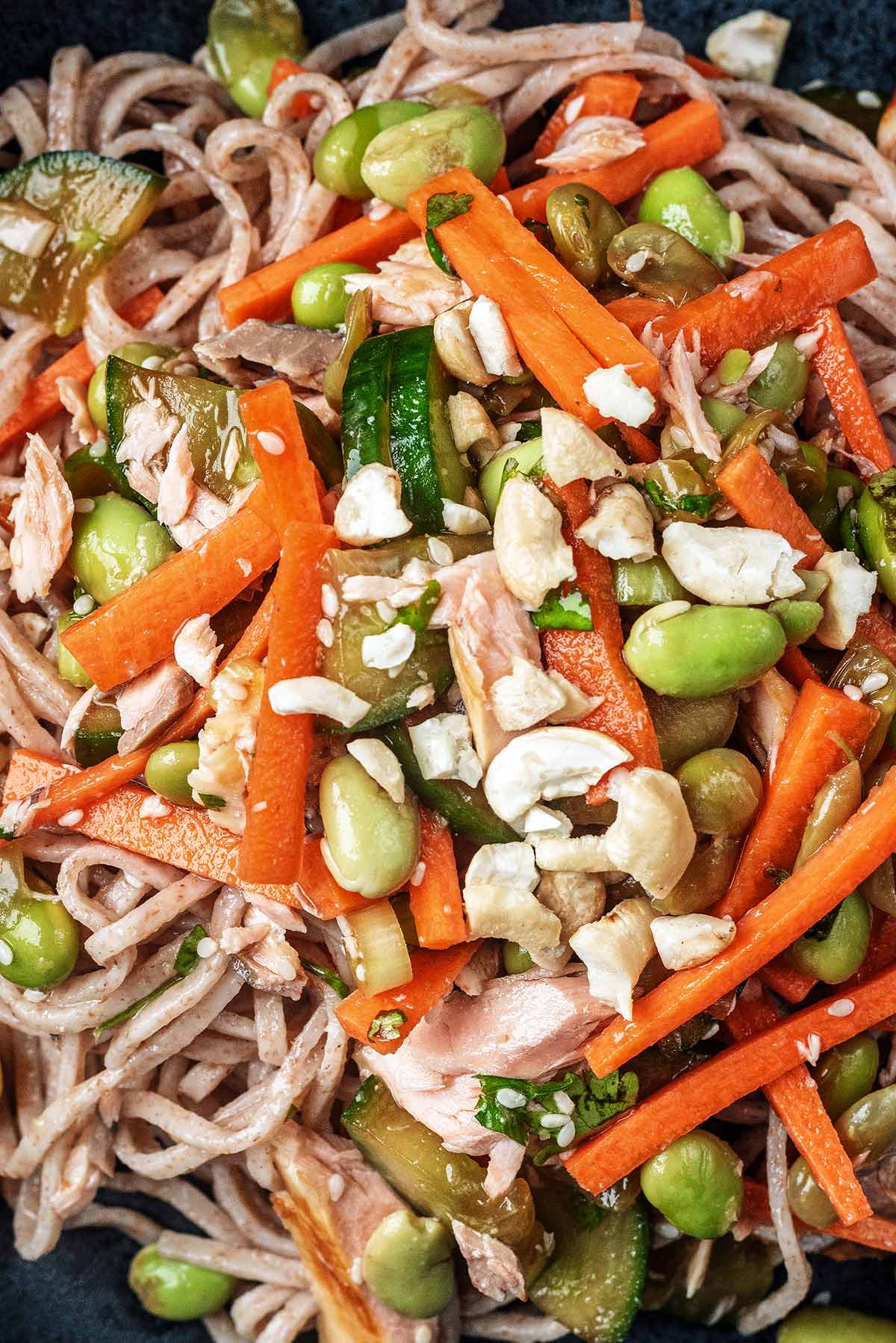 noodles mixed with carrot battens, edamame and cashews.