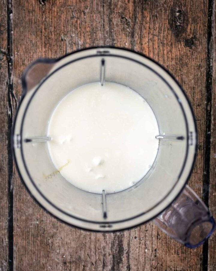 Cottage cheese and milk blended in a blender jug.