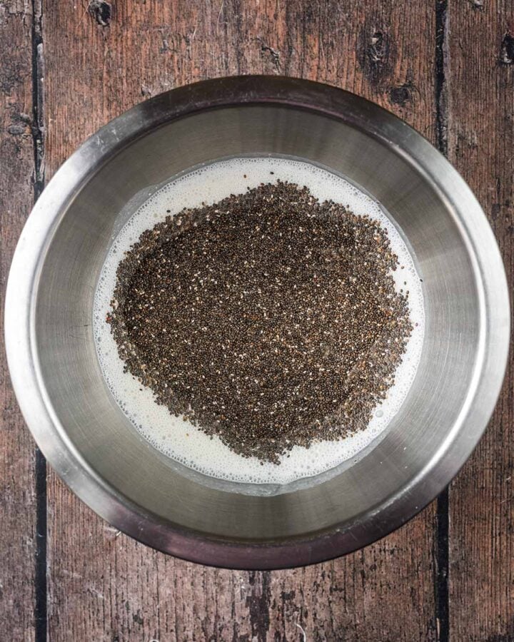 Blended cottage cheese, milk and chia seeds in a mixing bowl.