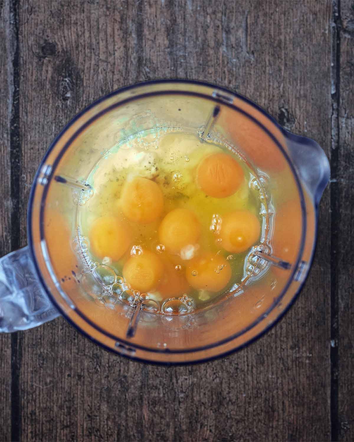 A glass measuring jug containing eggs and cottage cheese.