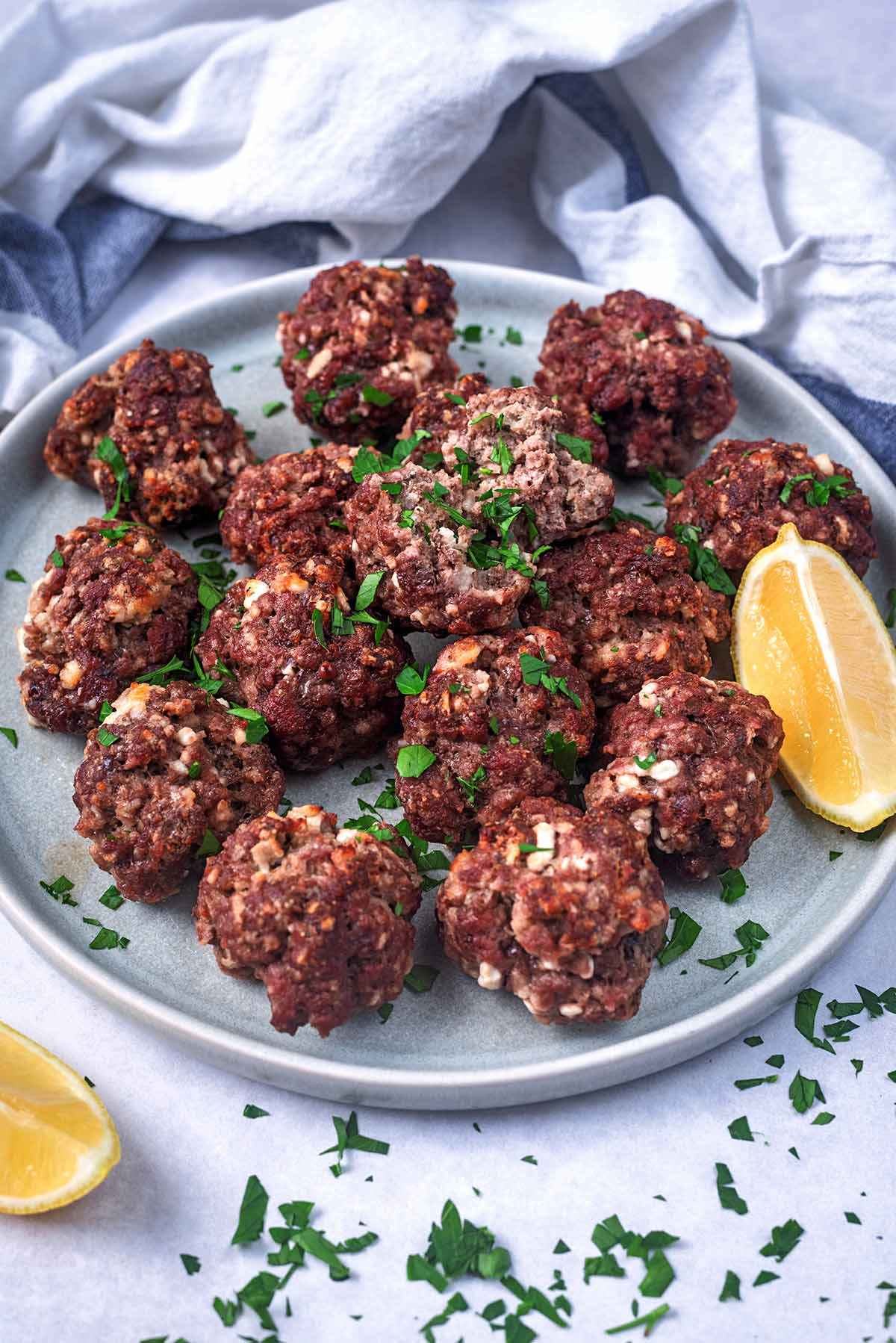 A plate of meatballs in front of a striped towel.