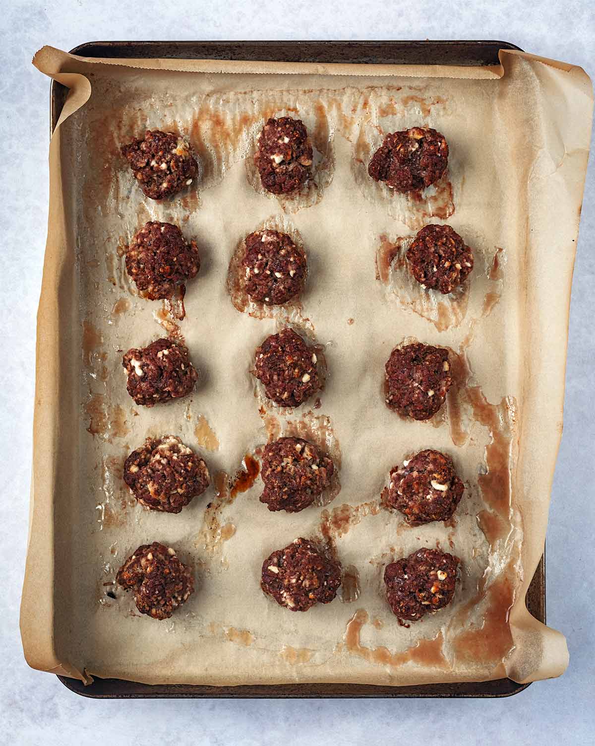 The meatballs cooked on the baking tray.