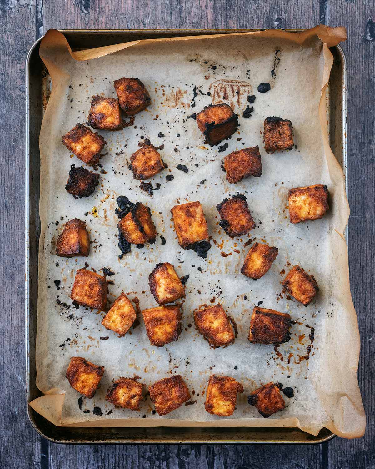 Crispy cooked tofu cubes on the baking tray.