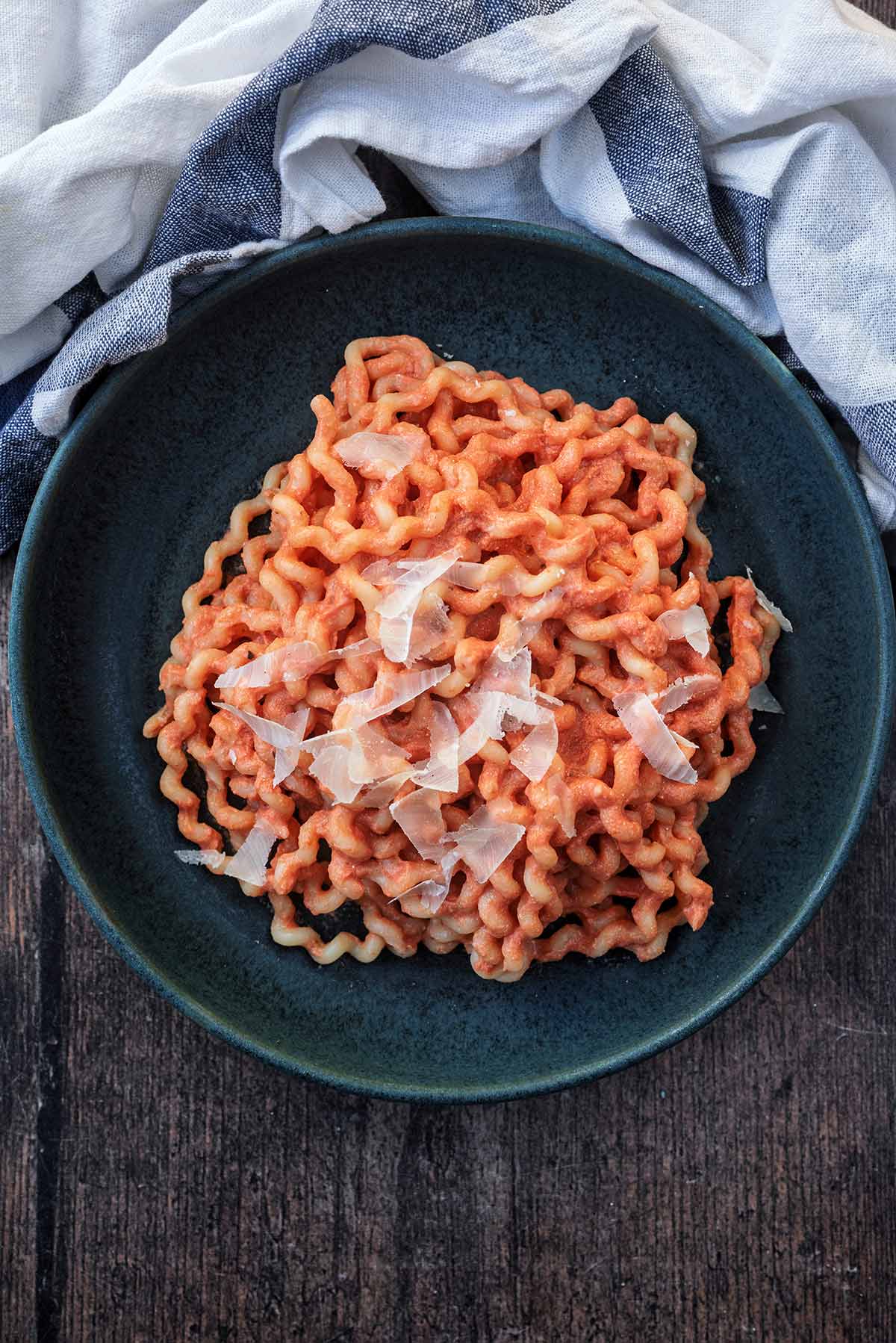A bowl of pasta in a creamy tomato pasta sauce.