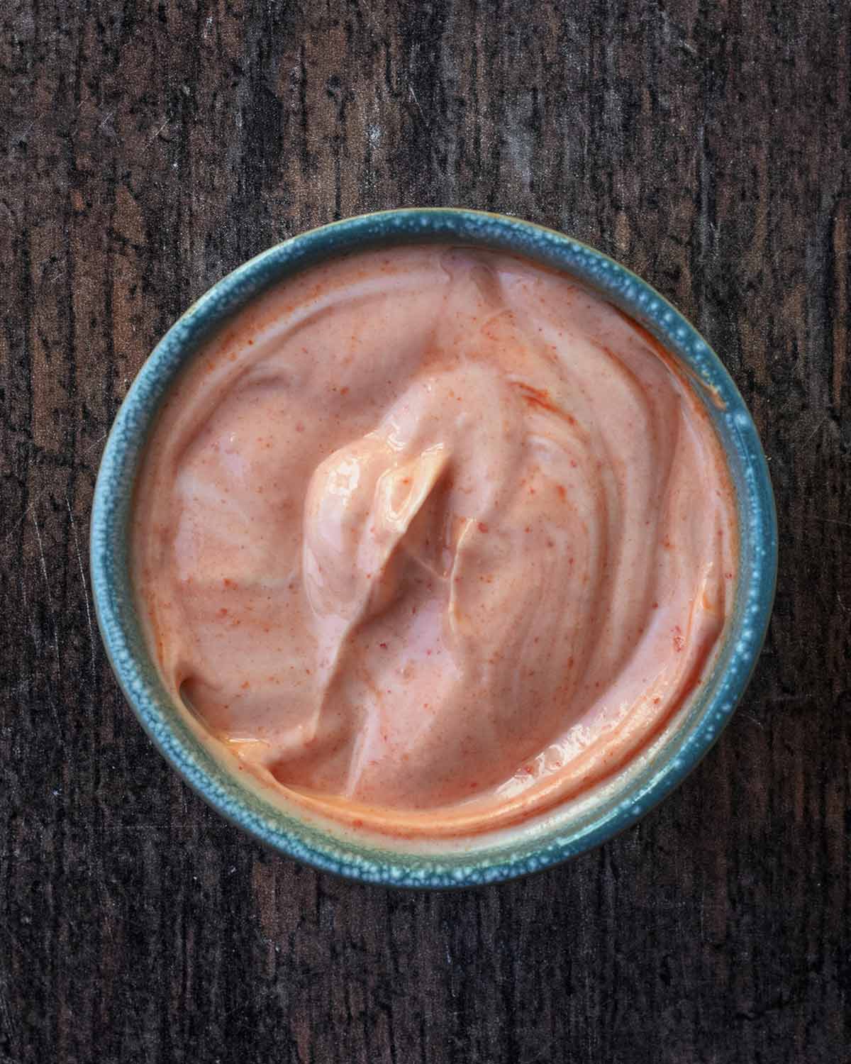 A small bowl of pink coloured sauce.