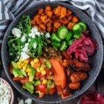 Hot honey chicken bowl next to a striped towel.