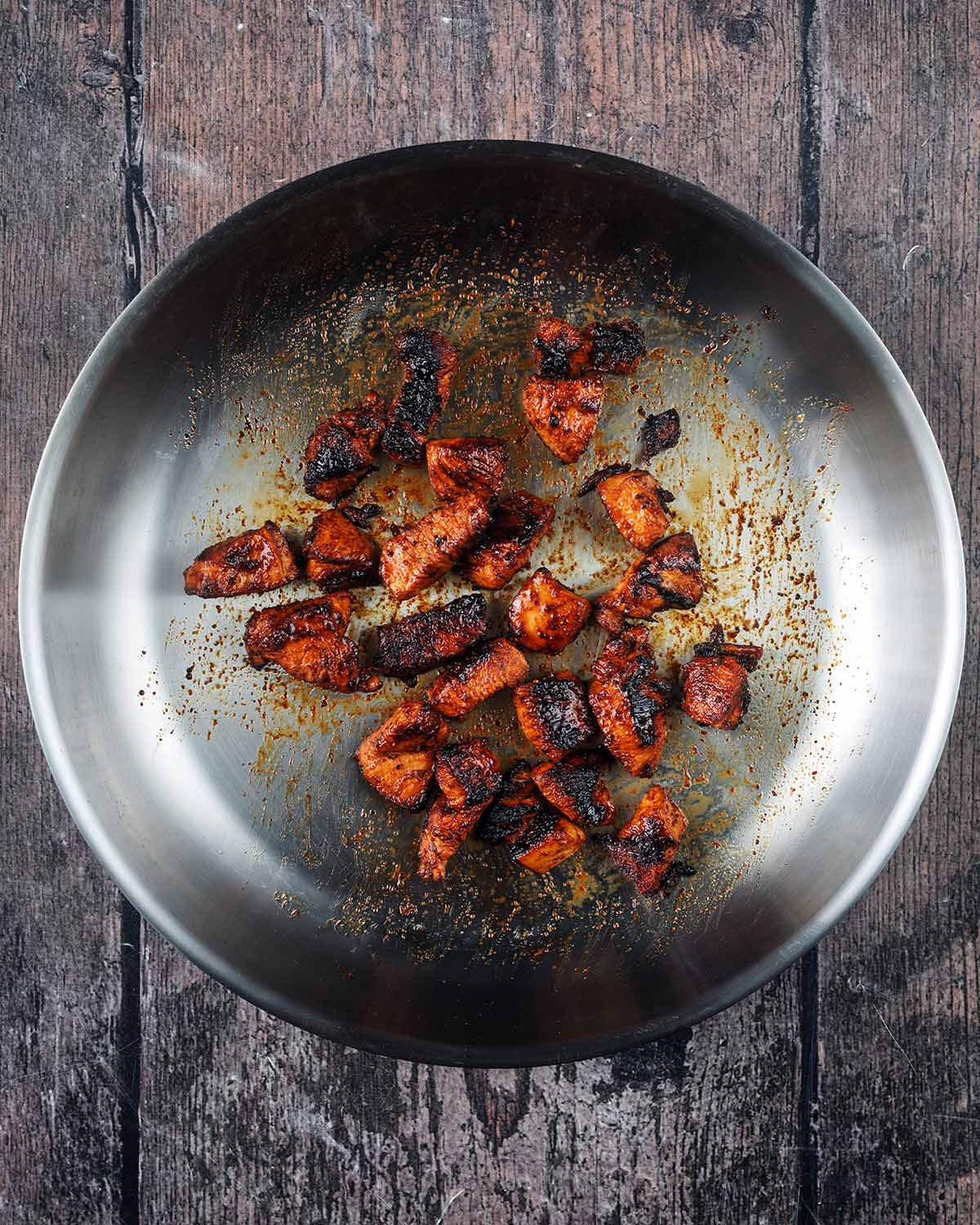 Cooked chicken cubes in the pan.