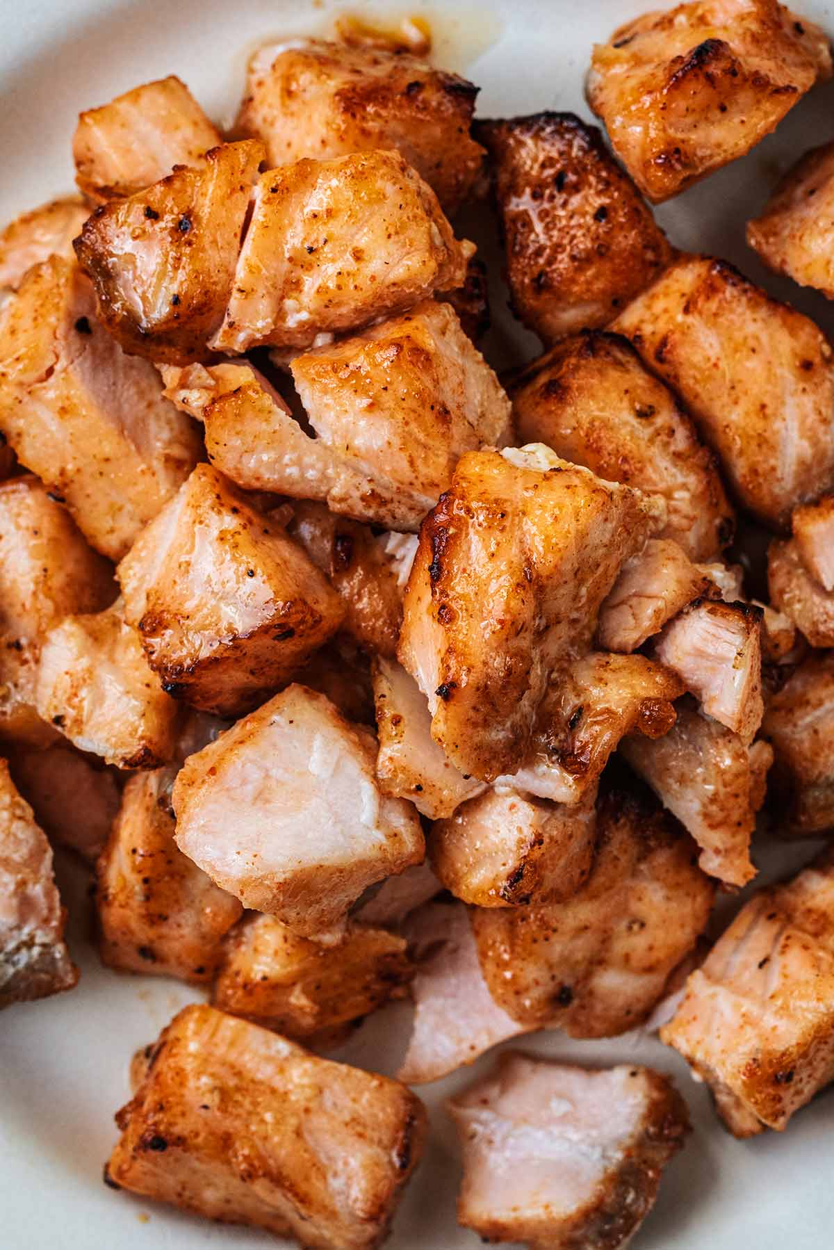 Cooked chunks of salmon coated in honey and spices.