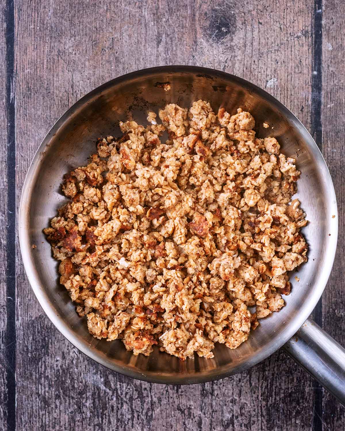 Cooked clusters of oats in the pan.