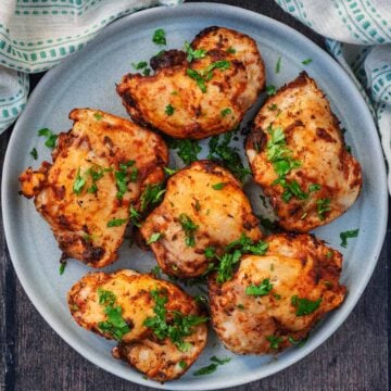 Six Buffalo Chicken Thighs on a grey plate.