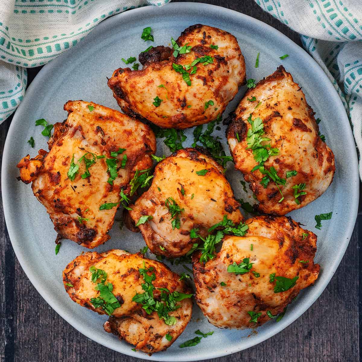 Six Buffalo Chicken Thighs on a grey plate.