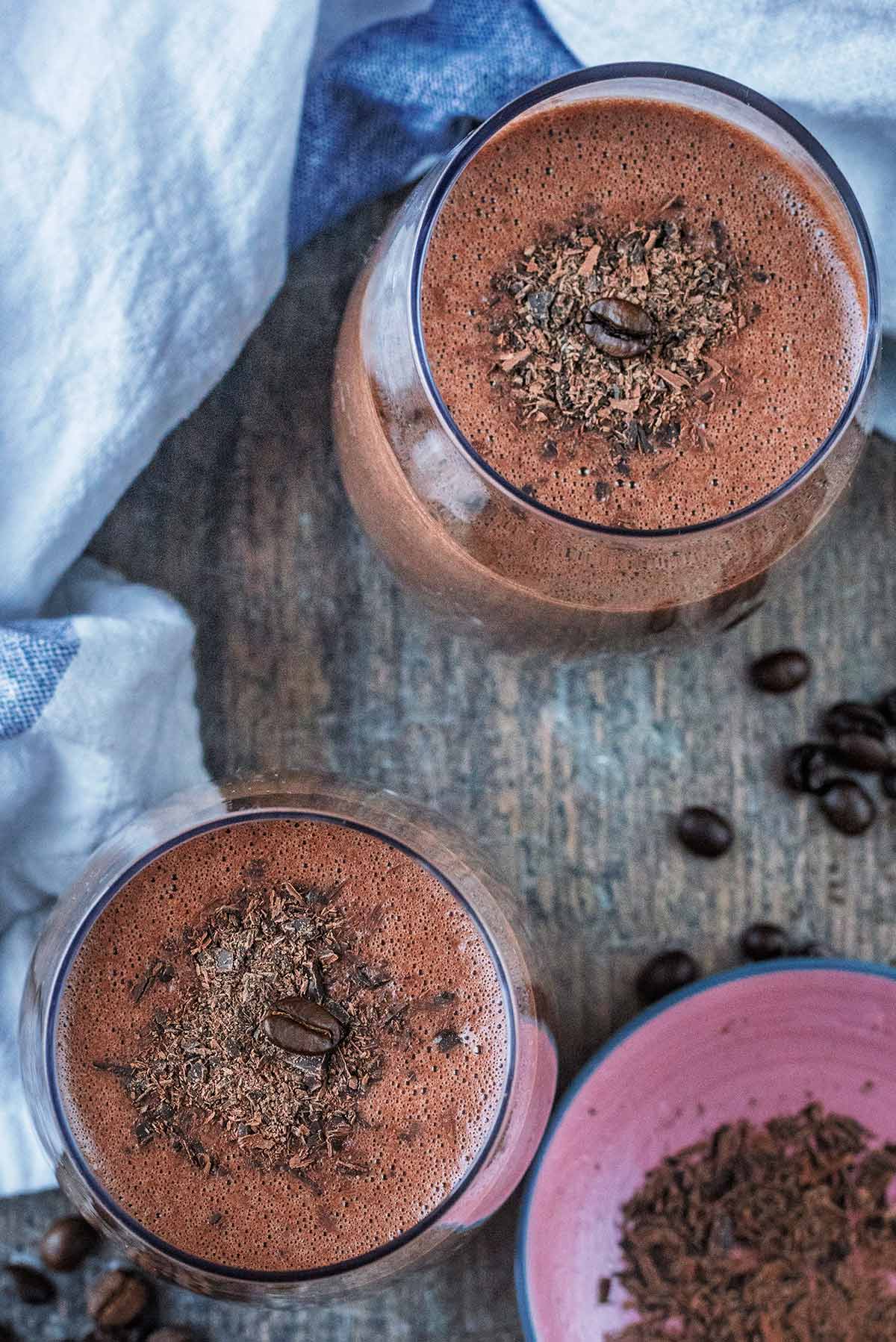 Two coffee smoothies in glasses as viewed from above.