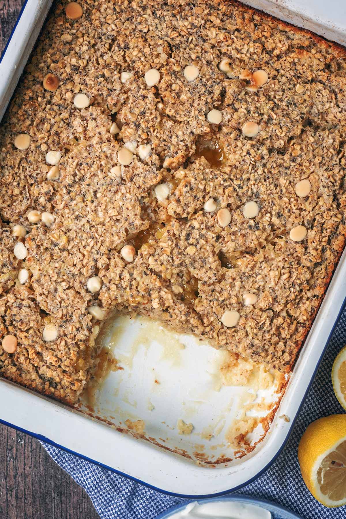 Baked oats in a baking dish with a portion removed.
