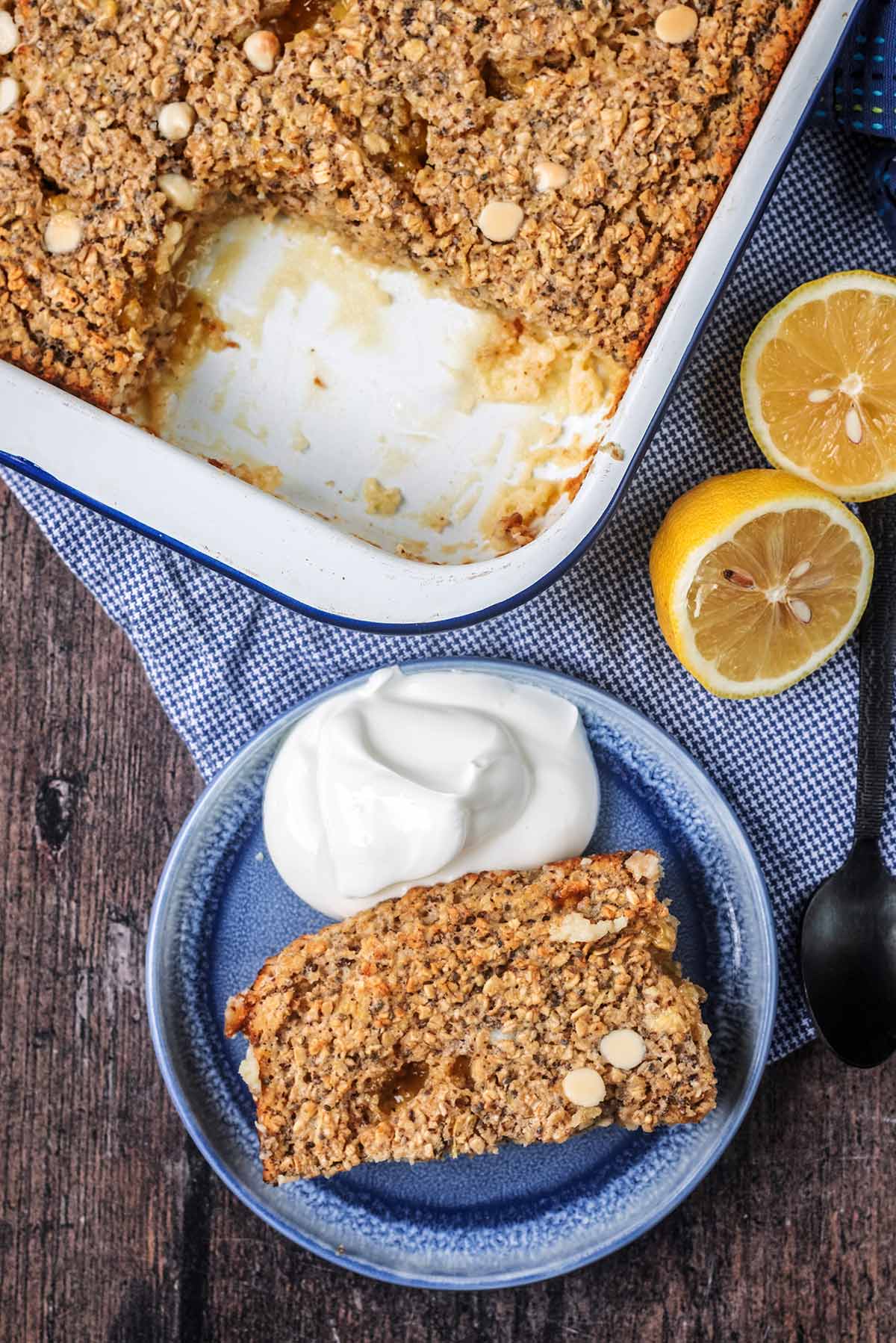 A portion of baked oats on a plate with a dollop of thick yogurt.