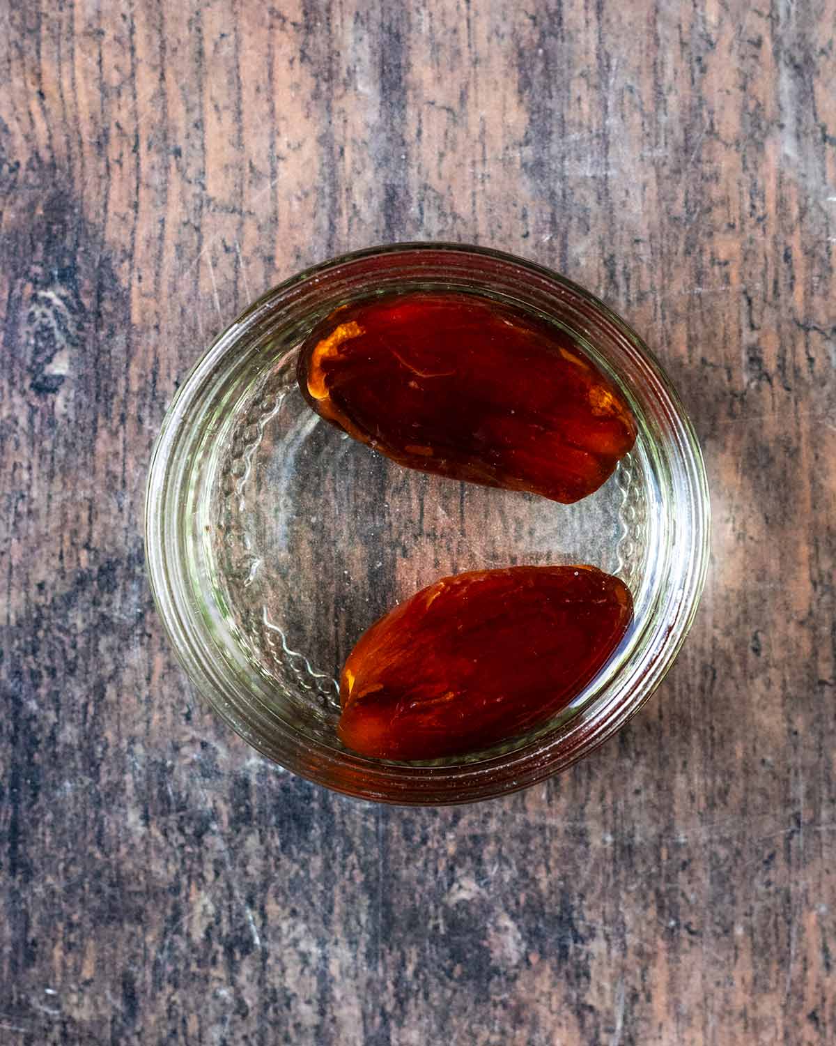Two dates soaking in water.