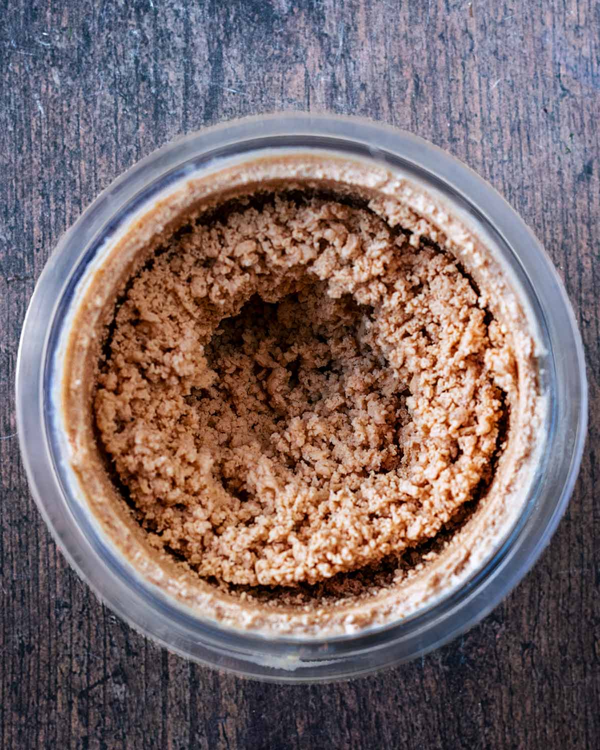 The processed pumpkin creami in the tub with a crumbly texture..