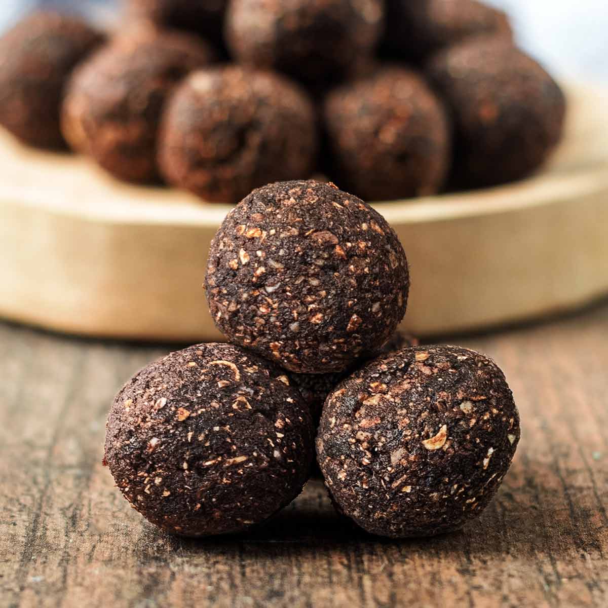 Three nut free energy balls stacked up in a triangle.