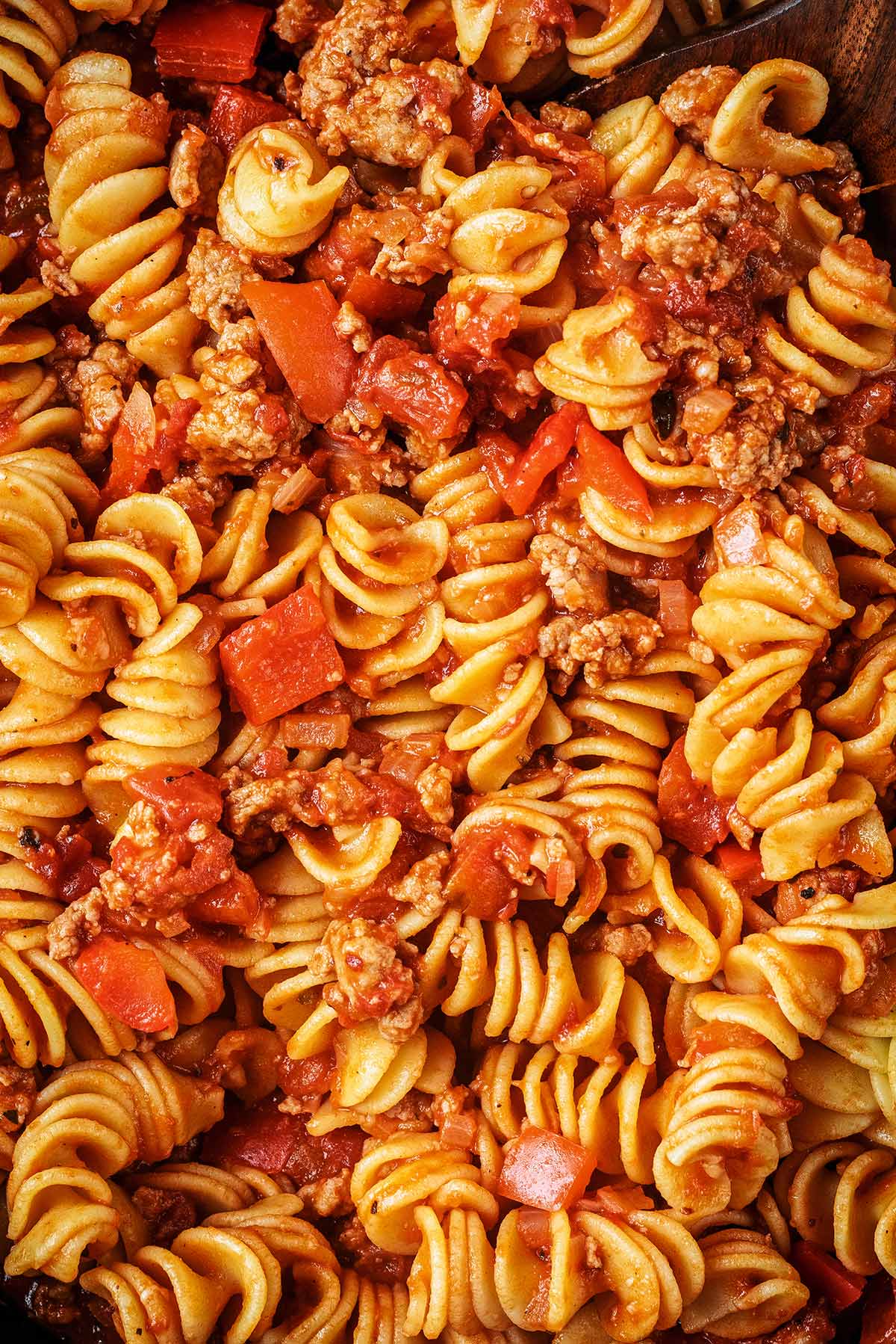 Cooked pasta, diced peppers and sausage meat cooked in a tomato sauce.