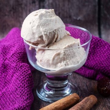 A serving glass with two balls of Ninja Creami sticky toffee pudding ice cream in it.