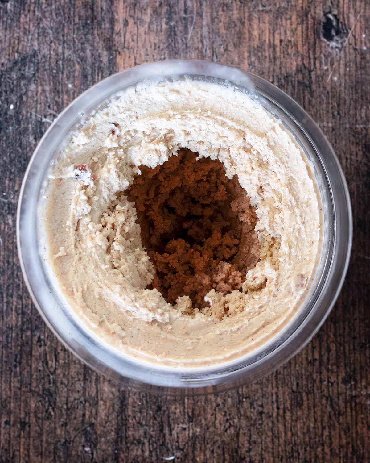 The processed ice cream in the Ninja tub with a crumbly consistency.