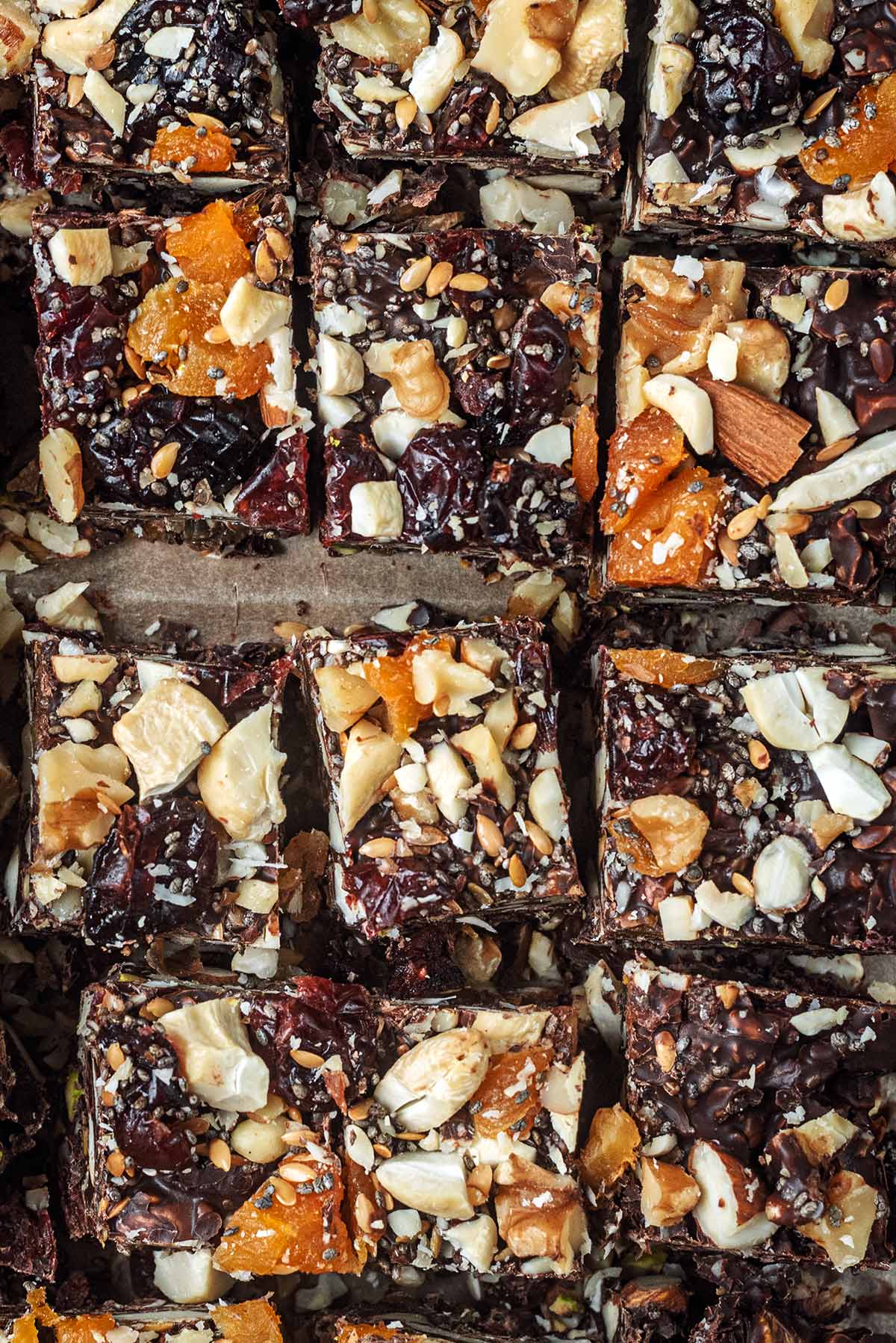 Squares of rocky road topped with dried fruit and chopped nuts.