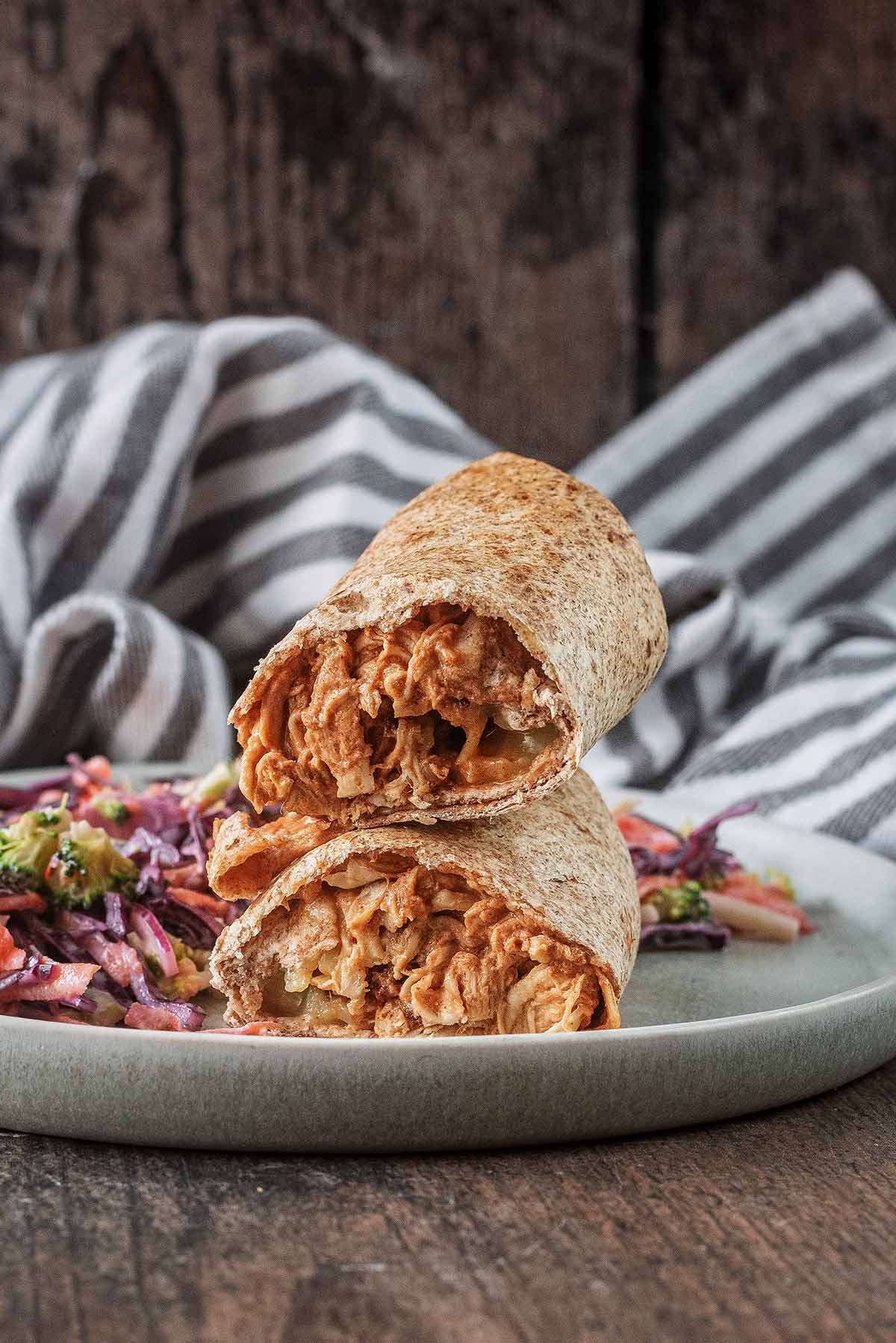 A barbecue chicken wrap, cut in half then stacked up.