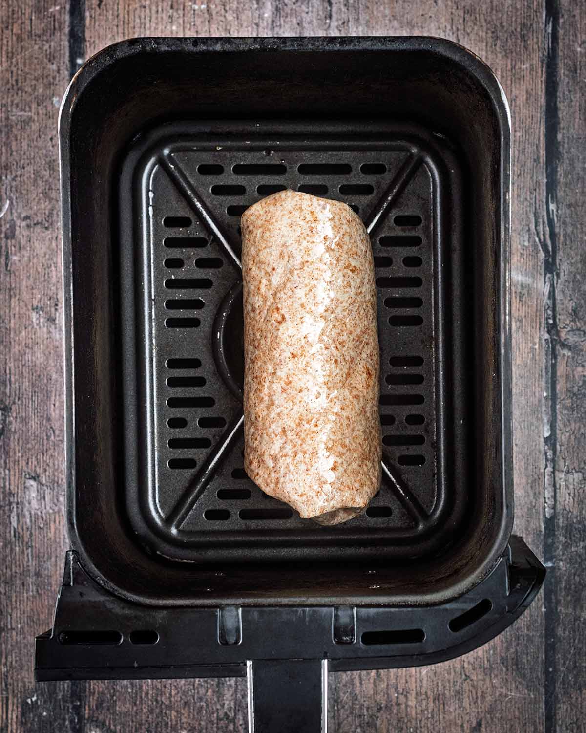 A folded wrap in an air fryer basket.