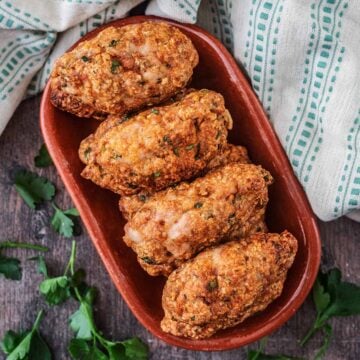 Baked chicken koftas in an oval serving dish.