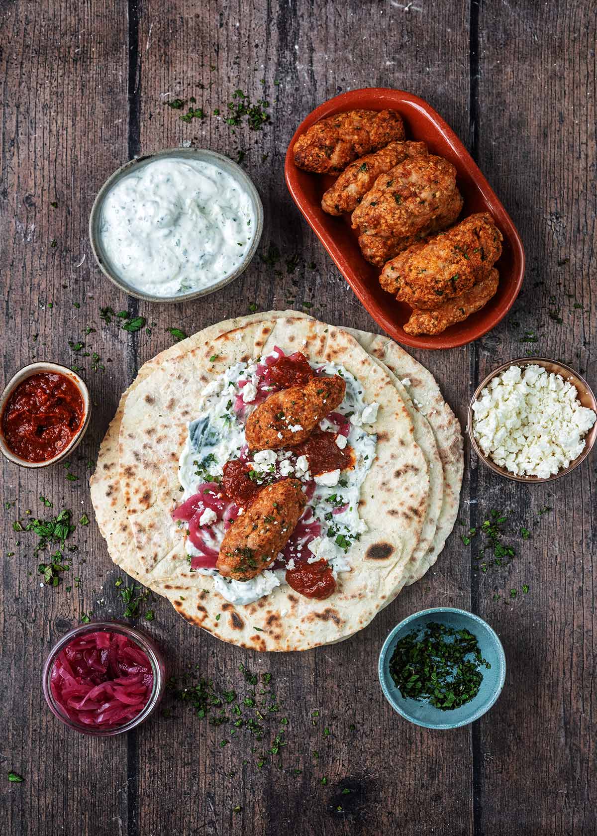 Large flatbreads topped with tzatziki, harissa, koftas and feta cheese.