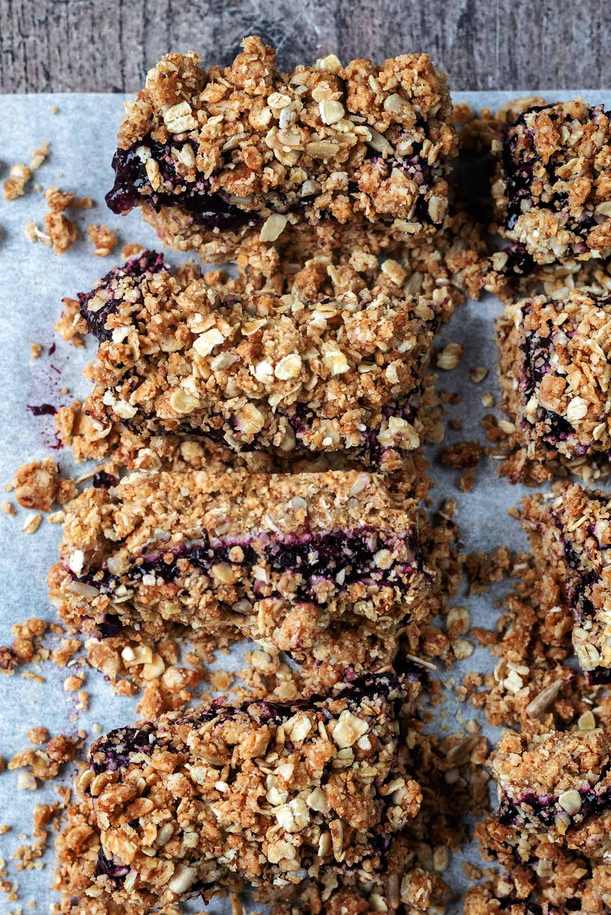 Four oat bars, on of which is on its side showing its jammy filling.