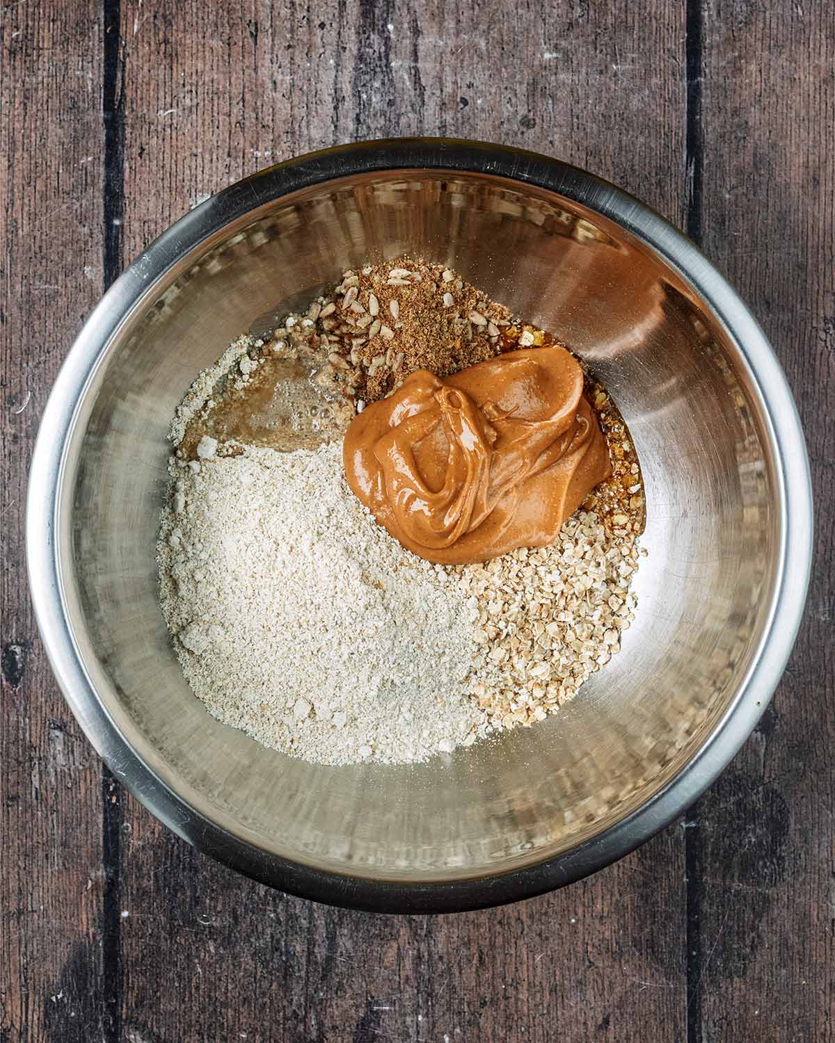 Oats, oat flour, peanut butter and seeds in a large mixing bowl.