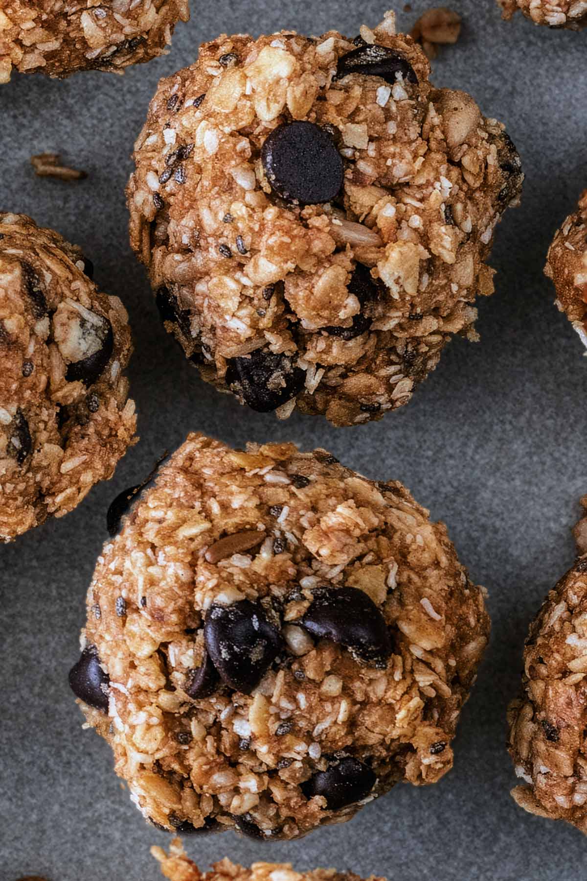 Two energy oat balls with chocolate chips in them.