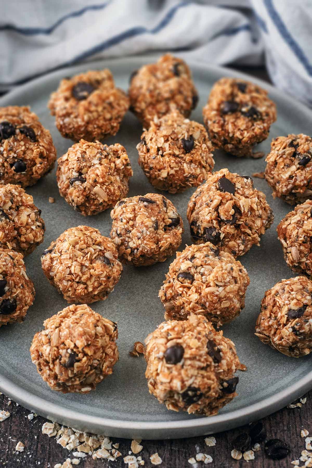 A plate of energy balls in front of a striped towel.