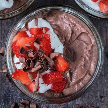 Greek yogurt chocolate mousse topped with yogurt and chopped strawberries.